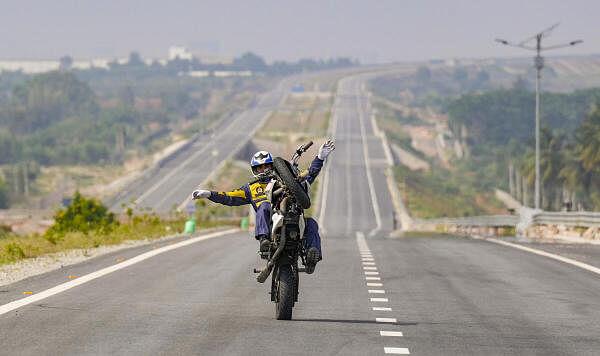 Havaldar Manish, a member of the Army Service Corps (ASC) 'Tornadoes' of the Indian Army, rides a motorcycle in an attempt to break the world record for the 'lo<em></em>ngest no-hands basic motorcycle wheelie', in Bengaluru