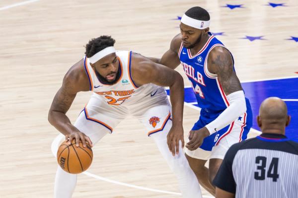 Mitchell Robinson #23 of the New York Knicks backs into the paint as Paul Reed #44 of the Philadelphia 76ers defends during the first half of game 3 of the Eastern Co<em></em>nference first round at the Wells Fargo Center, Thursday, April 25, 2024, in Philadelphia, PA.