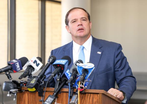 Suffolk County DA Ray Tierney speaking outside a courthouse 