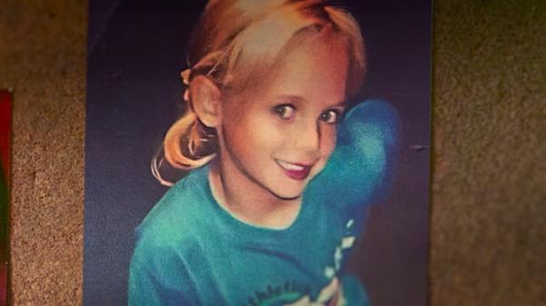 Family photo of JonBenét Ramsey smiling with her arm up from the new<em></em>lineary 'Cold Case: Who Killed Jo<em></em>nBenet Ramsey'