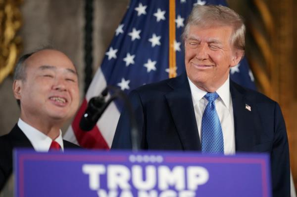 President-elect Do<em></em>nald Trump looks on as SoftBank CEO Masayoshi Son delivers remarks at Trump's Mar-a-Lago resort on December 16, 2024 in Palm Beach, Florida. 