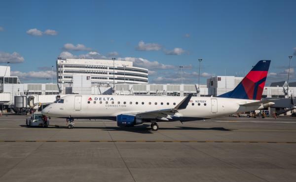 A delta airlines plane parked at an airport.