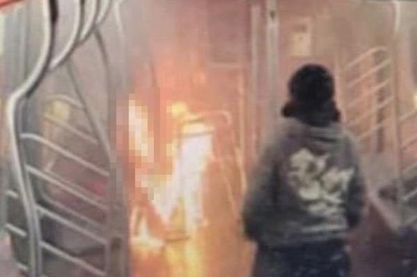 Subway surveillance images show  a suspect watching the woman burning.