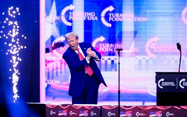 President-elect Do<em></em>nald Trump mimics a golf swing o<em></em>nstage at Turning Point's annual AmericaFest.