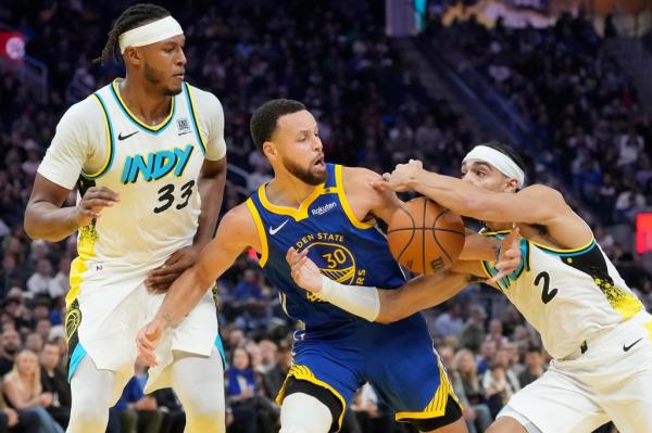 Golden State Warriors guard Stephen Curry (30) battles for the ball with Indiana Pacers center Myles Turner (33) during the first half of an NBA basketball game in San Francisco on Monday, Dec. 23, 2024. 
