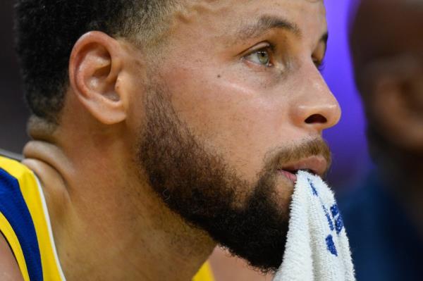 Golden State Warriors guard Stephen Curry (30) sits on the bench against the Indiana Pacers in the fourth quarter at Chase Center.