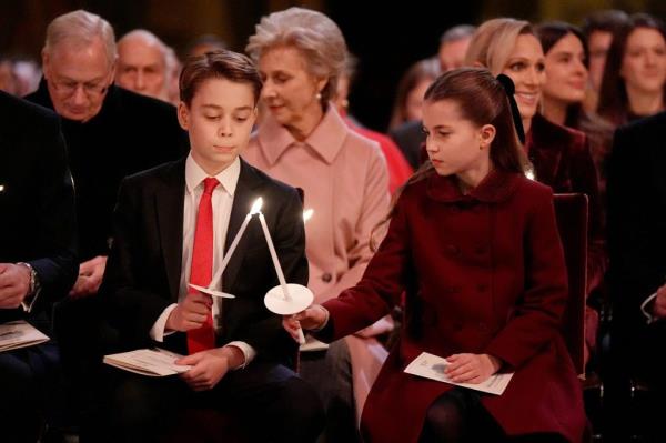 Prince George and Princess Charlotte of Wales attending the 'Together At Christmas' Carol Service at Westminster Abbey in London, holding candles.