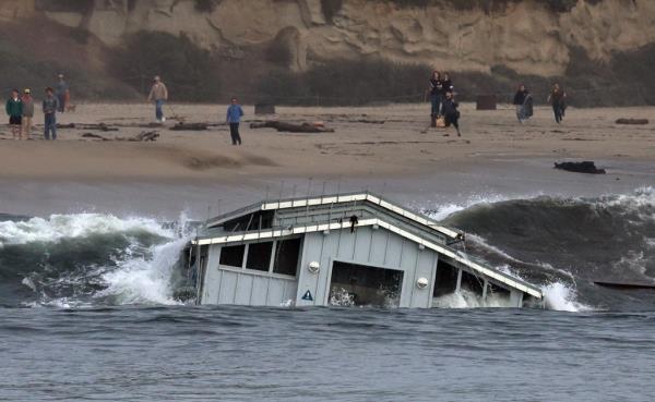 A building from a wharf collapse floats in the ocean Monday, Dec. 23, 2024, in Santa Cruz, Calif. 