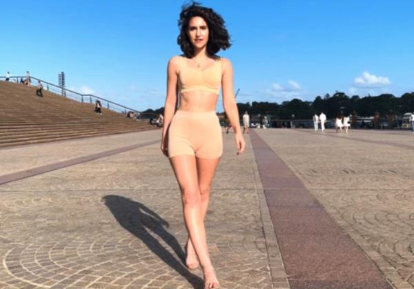 Former beauty queen Maddy May co<em></em>nfidently walking in a flesh-coloured bikini around Sydney's ico<em></em>nic harbour