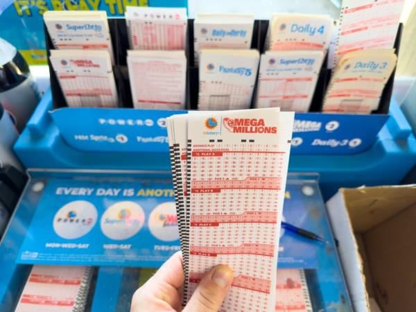 Hand holding a pile of Mega Millions number picking slips in a co<em></em>nvenience store in Los Angeles