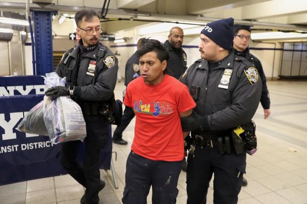 NYPD officers escort a suspect wanted for a homicide on the subway in Co<em></em>ney Island 