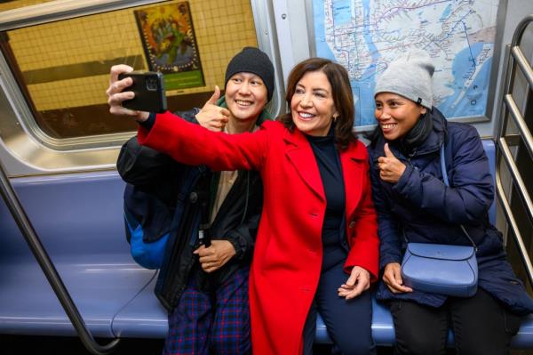 A photo posted by New York Governor Kathy Hochul shows her taking selfies with subway riders as she touts a safer train system.