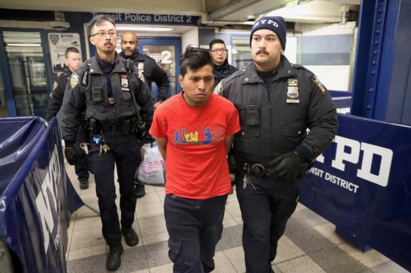 Police arresting the man accused of lighting a woman on fire on the F train in Brooklyn on Dec. 22, 2024.