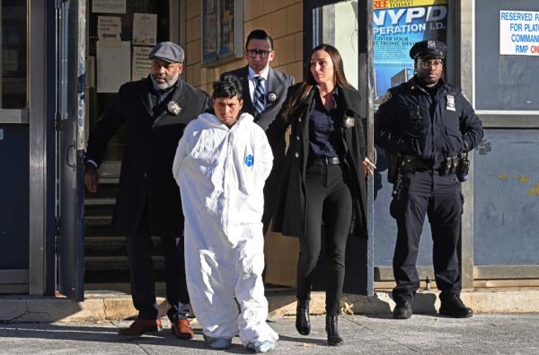 Sebastian Zapeta - Calil in a white jumpsuit being escorted from the 60th Precinct to court to face murder charges