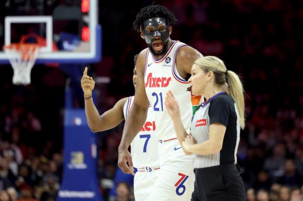 Joel Embiid #21 of the Philadelphia 76ers argues a call with referee Jenna Schroeder #20