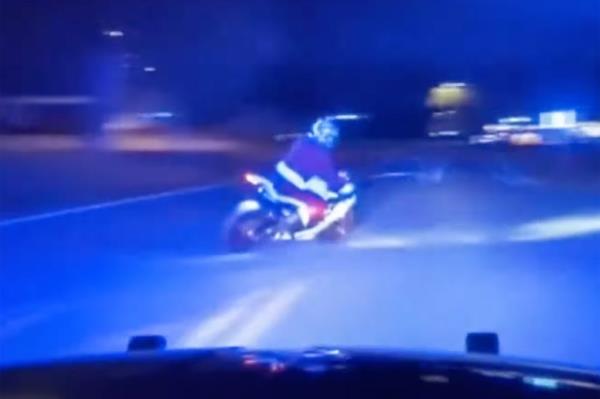 Florida Highway Patrol Santa riding a motorcycle on a road at night