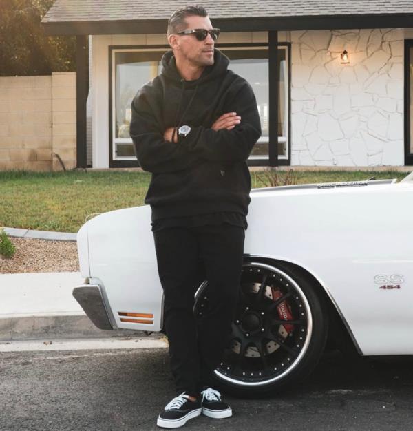 Fitness influencer Miguel Angel Aguilar leaning against a car