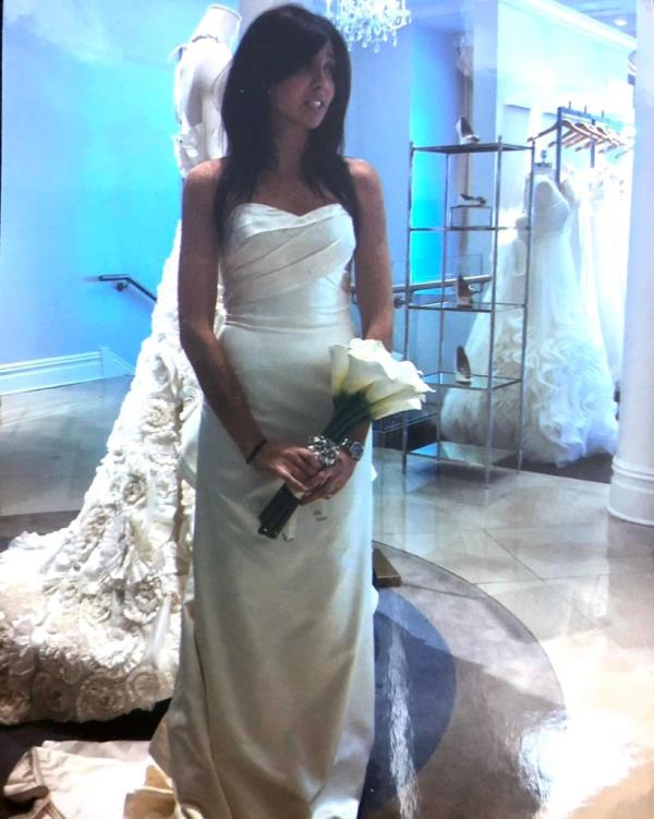 Ellen Greenberg poses while trying on wedding dresses