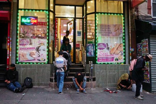 Drug addicts sitting outside a nail salon on Melrose Avenue on Aug. 30, 2024.