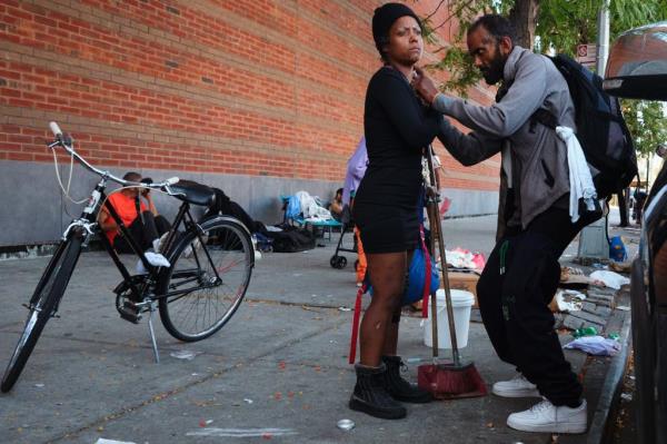 A man injecting drugs into the neck of a woman in The Hub on Sept. 10, 2024.