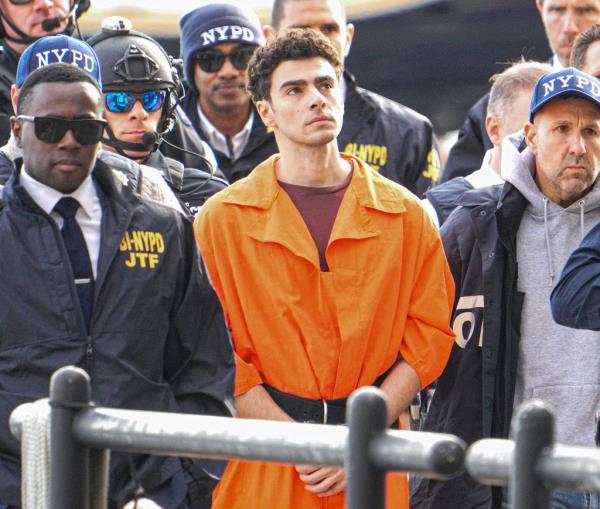 Luigi Mangione surrounded by law enforcement after arriving in New York City. 