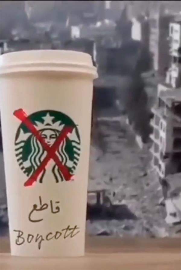 A white Starbucks coffee cup with a red X and "boycott" written on it over warzone image.