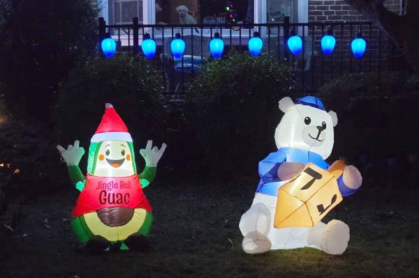 Renee Wygodaa??s Christmas and Hanukkah ourdoor decorations including an avocado in a santa outfit and a white bear holding a yellow dreidel