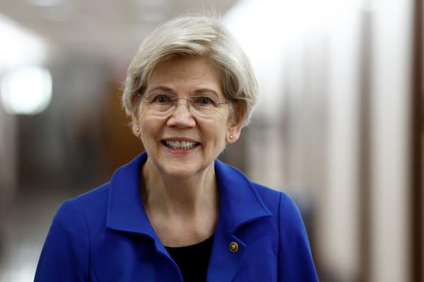 U.S. Senator Elizabeth Warren smiles as she walks in the Dirksen Senate Office Building on Capitol Hill in Washington, U.S., December 12, 2024. 