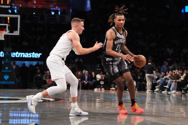 Noah Clowney #21 of the Brooklyn Nets dribbles the ball during the game against the Cleveland Cavaliers.