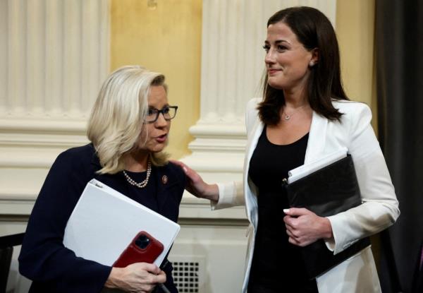 Cheney (R-WY) talks with Cassidy Hutchinson, who was an aide to former White House Chief of Staff Mark Meadows, after Hutchinson co<em></em>ncluded her testimony during a public hearing of the U.S. House Select Committee