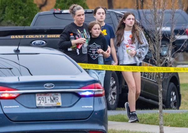 Young people exiting a church near Abundant Life Christian School, scene of a recent shooting, with police presence in the background, Tova Magnusson among them.