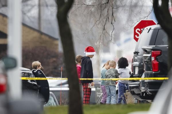 School children walking past police tape as they are escorted away from the scene of a shooting at Abundant Life Christian School in Madison, Wisconsin, USA, 16 December 2024.