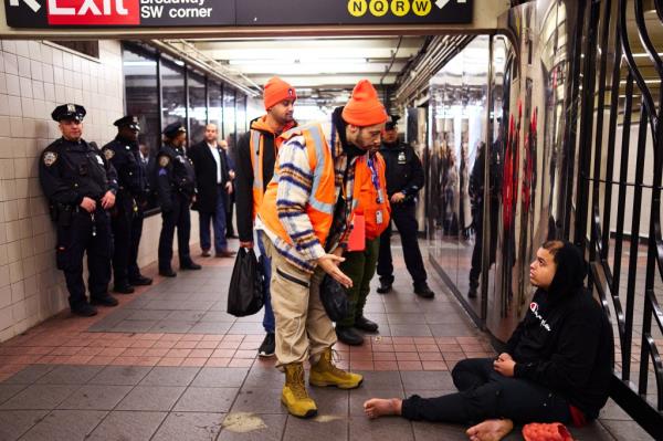 Members of the New York City Police Department(NYPD) and employees with the New York City Department of Homeless Services (DHS) assist a homeless man at the 34th StreetaHerald Square subway station as New York City Mayor Eric Adams and New York City Police Commissio<em></em>ner Jessica Tisch visited the station on Wednesday, December 11, 2024 in New York, N.Y.   