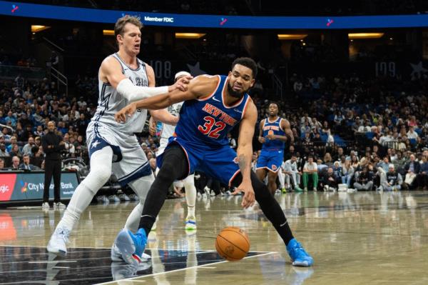 Knicks center Karl-Anthony Towns (32) dribbles the ball against Orlando Magic forward Moritz Wagner