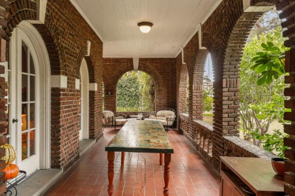 Red brick arches and a covered porch 