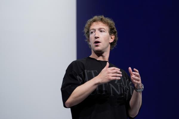 Mark Zuckerberg presenting the Orion AR glasses at the text<em></em>area Co<em></em>nnect co<em></em>nference in front of a white and blue wall, September 25, 2024, Menlo Park, California